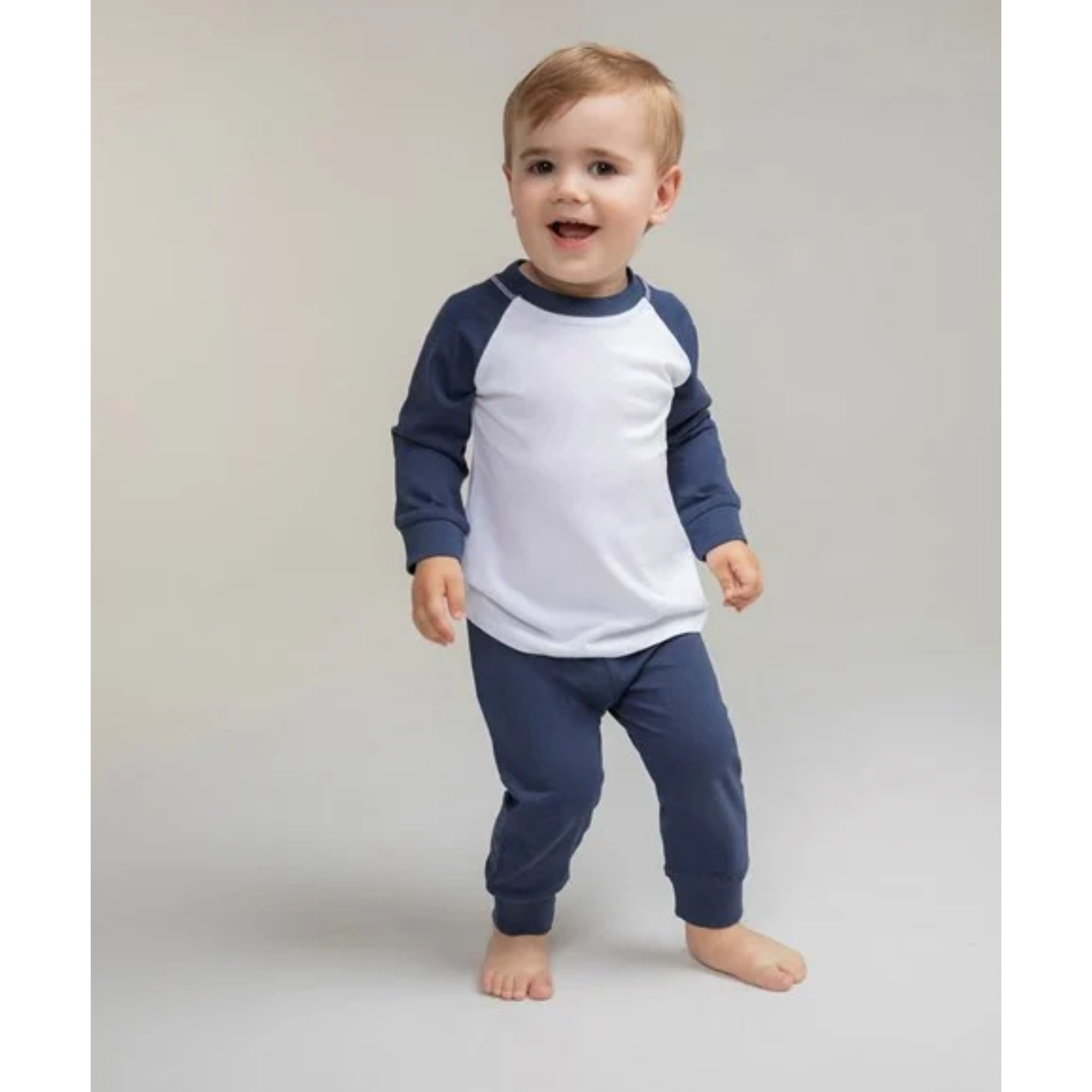 Child wearing a blue and white pajama set on a plain background
